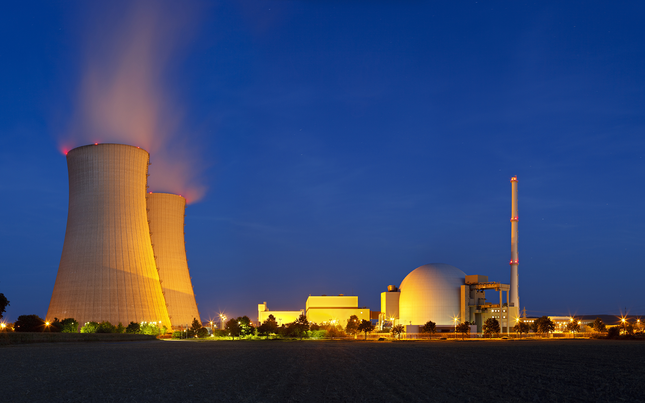 Panoramic shot of a large nuclear power station at night.